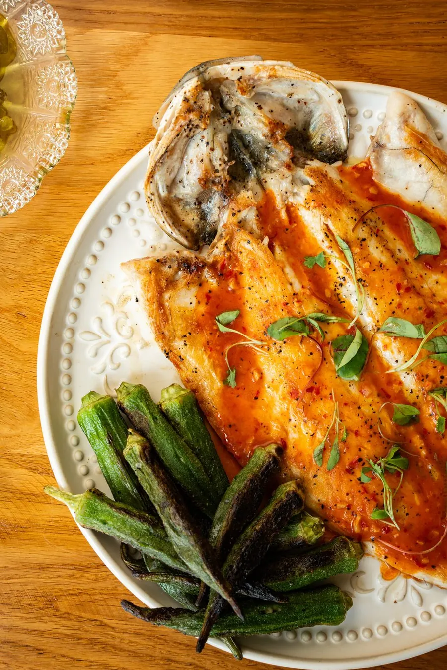 Whole grilled fish with charred okra and chili sauce at POPULAR, Encino